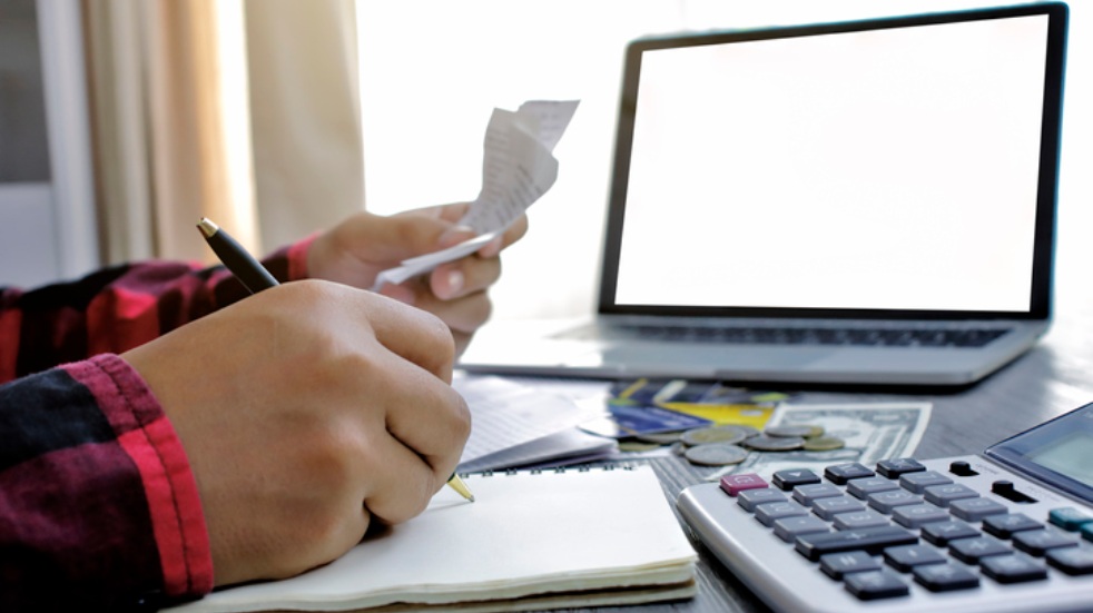 person budgeting at laptop